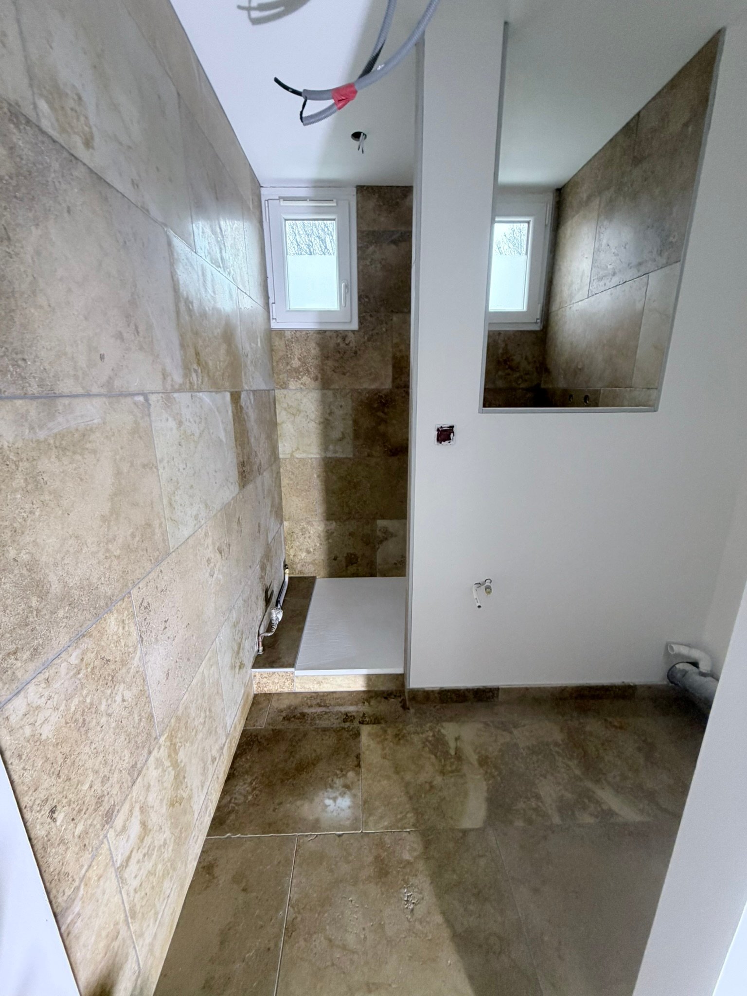 Pose travertin sol et mur salle de bain douche italienne en cours Kocak Cognin